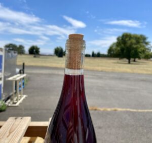 Close-up of a hot wine bottle pushing its cork out on a hot, sunny day at itä wines in Walla Walla